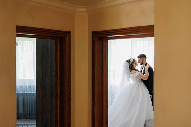 istock A bride and groom are standing in front of a wall 2209740122