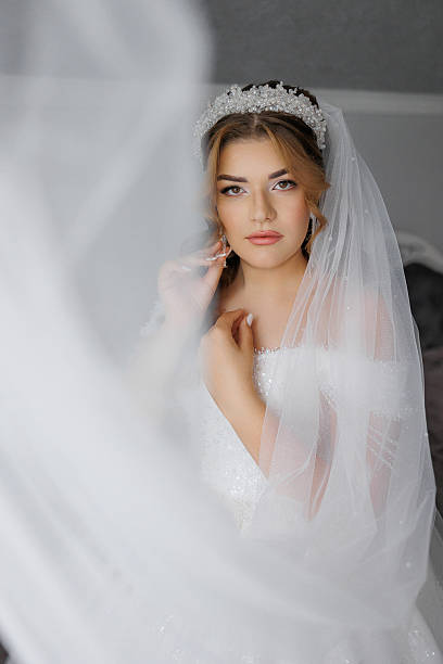istock A woman is wearing a white veil and a tiara 2209740132