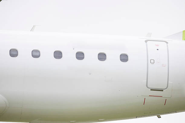 istock White airplane fuselage showing passenger windows and door 2209742362
