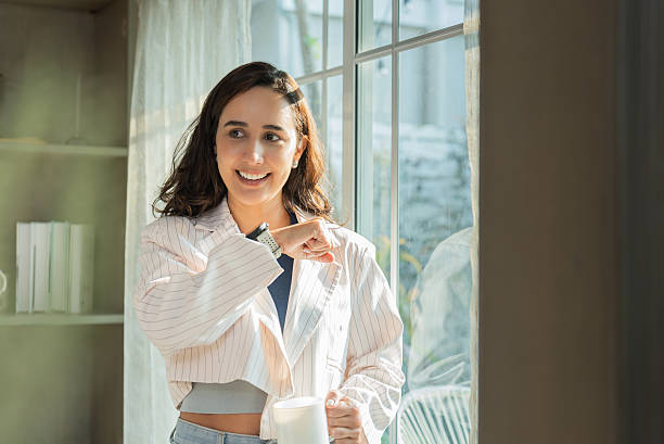 istock Woman Using Smartwatch Voice Assistant While Enjoying Morning Light 2209748254