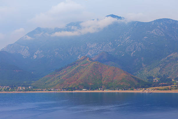 emerald sea bay with mountain near a coast