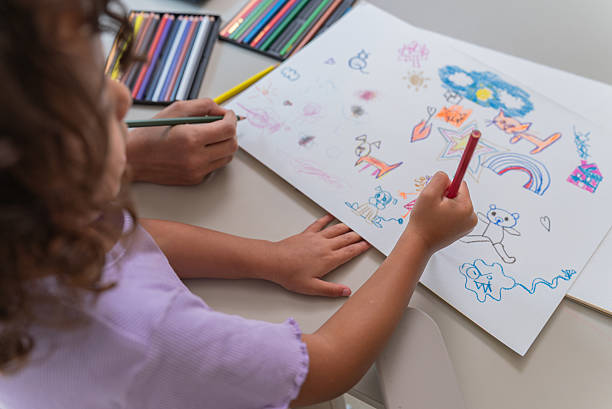 istock Mother and Daughter Drawing Together at Home — Overhead View 2209748628