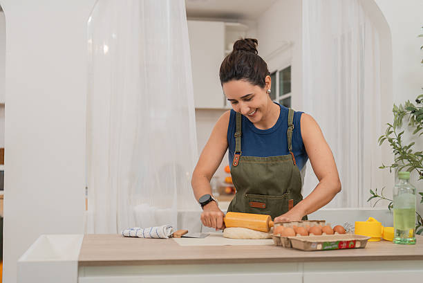 istock Woman Baking at Home While Wearing a Smartwatch 2209749141