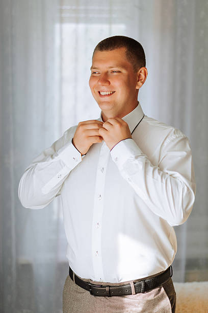 istock A man in a white shirt and black pants is getting ready to go out 2209750067