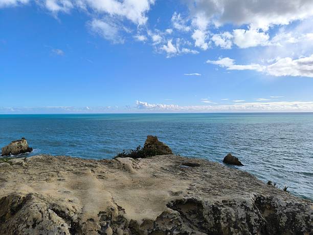 istock Sunlit Rocks Framing a Turquoise Seascape 2209750683