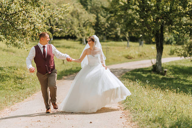 istock A bride and groom are walking down a dirt road 2209751484