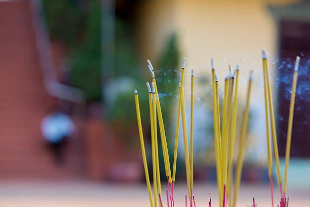 istock Burning incense sticks release fragrant smoke in temple. 2209751786