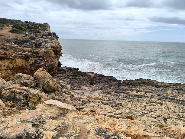 istock Gloomy Coastal Scene with Rocks and Rolling Waves 2209753415