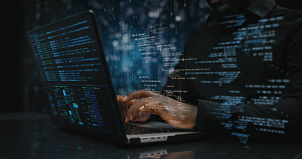 hands of male sitting in front of computer, focused on developing code for ai driven applications - hacker imagens e fotografias de stock