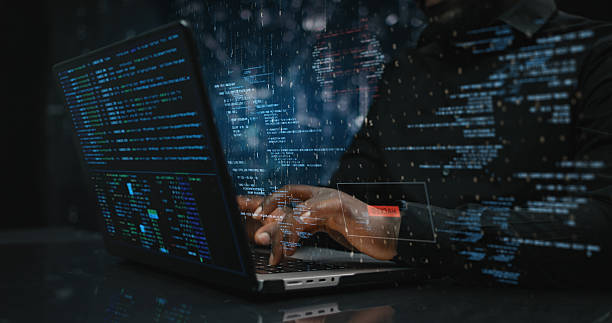 istock Hands of male sitting in front of computer, writing on keyboard focused on hacking as blue team or red team specialist searching for any vulnerability in system 2209753475
