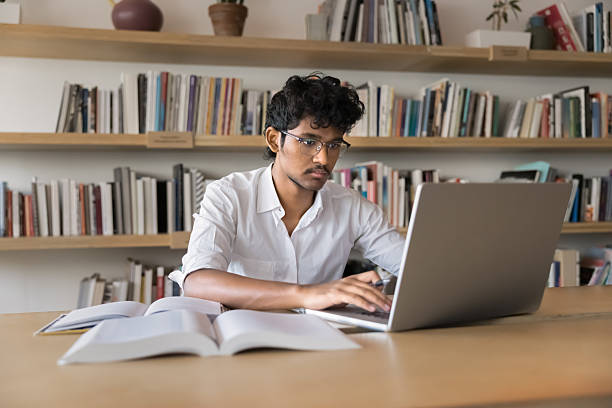 istock Serious young Indian student man in glasses typing on laptop 2209753546
