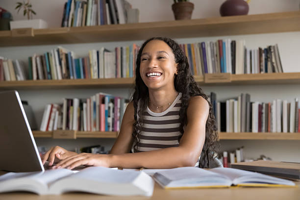 istock Happy fresh African student girl working hard in library 2209753818