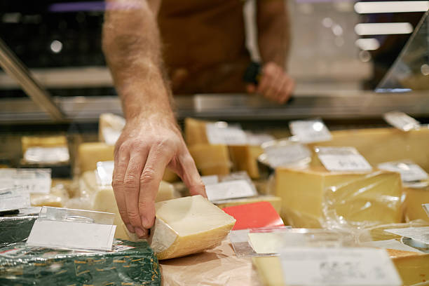 istock Selecting Various Cheeses at Specialty Shop Counter 2209753984