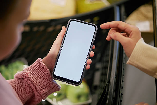 istock Person Showing Smartphone Screen While Shopping in Supermarket 2209754729