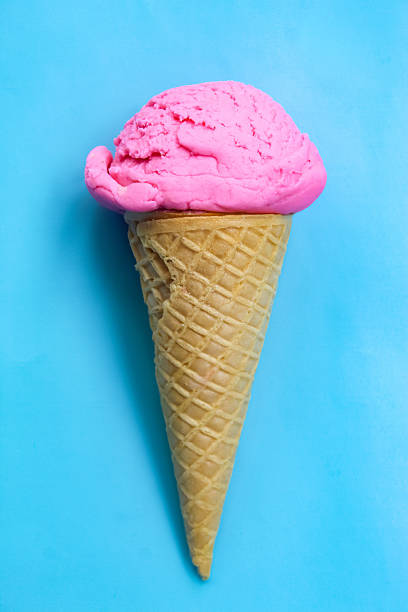 strawberry flavored ice cream cone on blue background