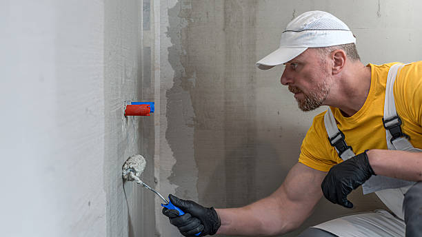 istock A worker applies a liquid membrane using a paint roller. Foolproof waterproofing under a tile in shower cubicle. 2209756764