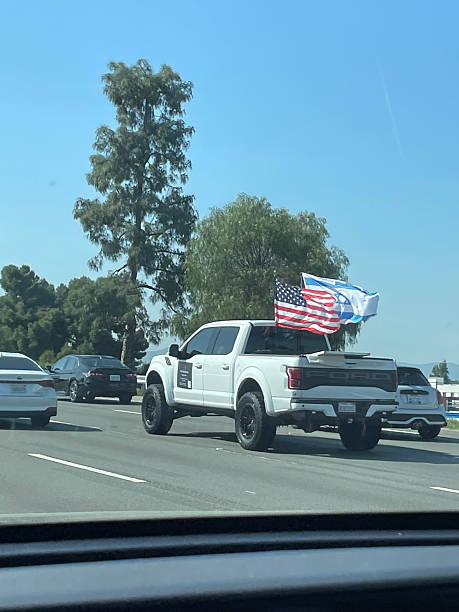 Los Angeles, United States - April 7th 2025: Pick up with USA and Israel flags on the freeway in Los Angeles, California.
