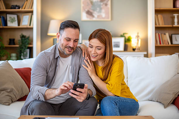 istock Couple looking funny video on the phone 2209761577