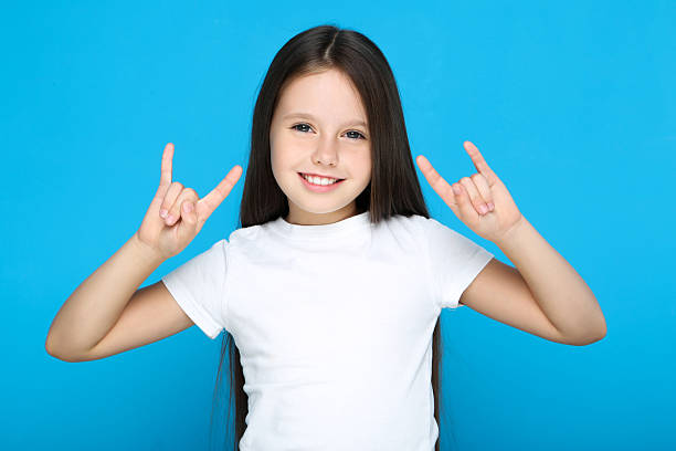 istock Young girl showing gesture by hands on blue background 2209763416