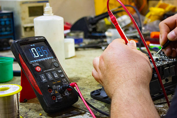 istock Voltage meter and man hands are repairing electronic circuit. Electoronic fixing concept. 2209764866