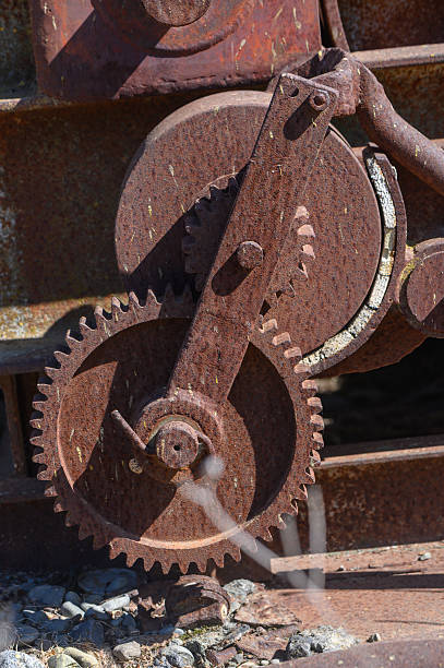 istock Rusty gears intertwining in a forgotten industrial landscape under bright sunlight 2209765766