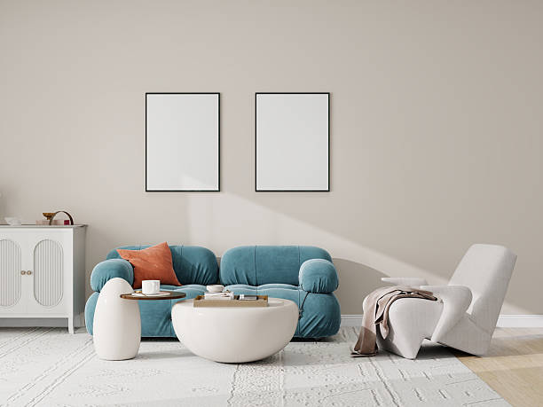 istock Modern minimalist living room with beige walls, featuring a gray sofa with a black throw blanket and white pillow, a hanging plant in a white pot, and a potted plant on a wooden stand. Neutral tones, cozy, and stylish. 2209769421