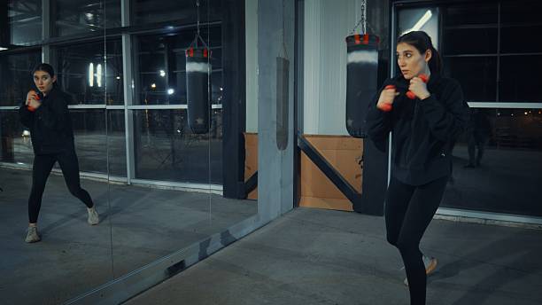 istock Young woman training with dumbbells in a gym 2209770752