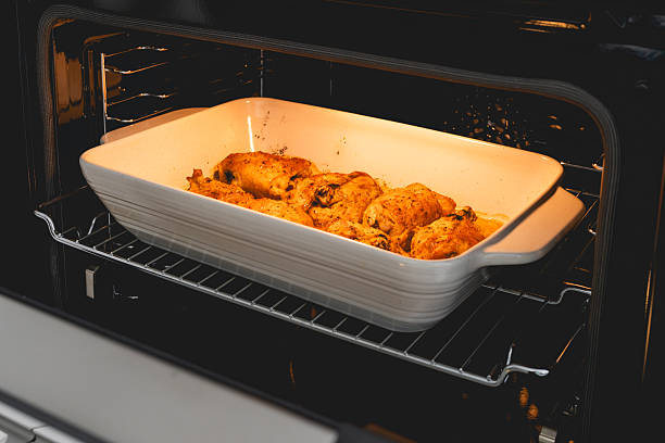 Chicken thighs roast to perfection in the oven, turning golden and juicy.