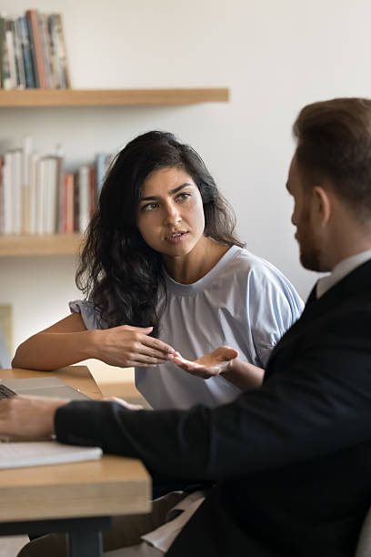istock Serious young Indian manager woman talking to boss at workplace 2209774520