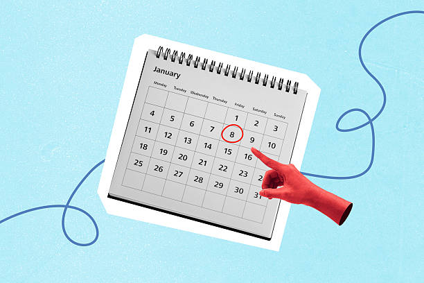 Hand pointing on important date in calendar