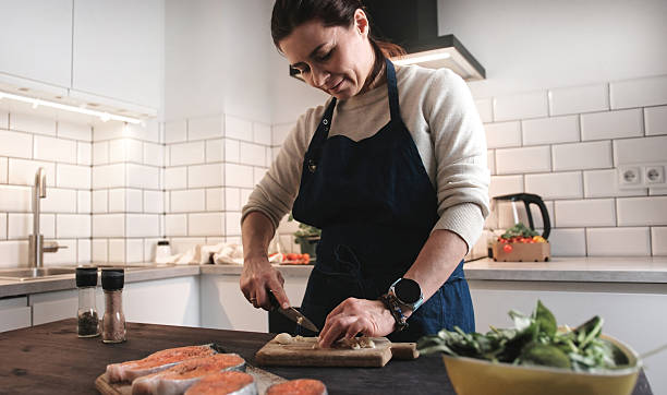 istock Woman Cutting A Garlic, Cooking Dinner In A Kitchen 2209779042