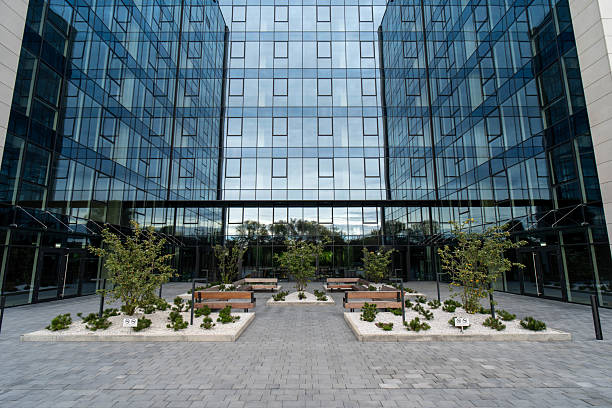 istock Modern Glass and Metal Building with Paved Plaza and Greenery 2209782784