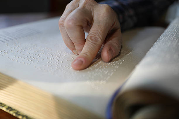 istock Blind Woman Over 50 Reading Braille Book 2209784325