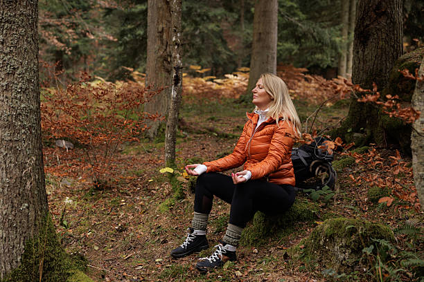 istock Woman Meditates Peacefully in Autumn Forest Setting 2209784558