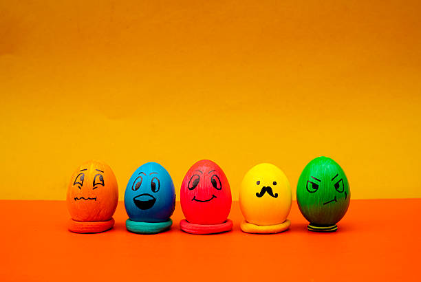Brightly colored emoji eggs lined up for a cheerful and playful Easter photo. Creative Easter Egg Faces With Fun Expressions