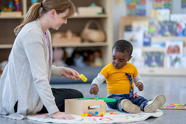 istock Teacher and Child Engaging in Educational Activities in Cozy Classroom Setting 2209789001