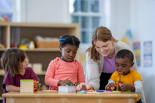 istock Preschool Teacher Engaging with Young Children During Educational Activities in Classroom 2209789003