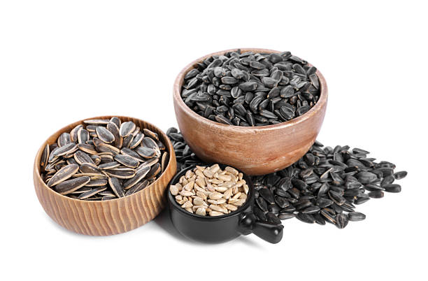 istock Sunflower seeds in bowls isolated on white 2209791088