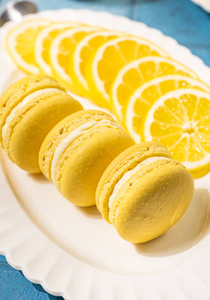 Lemon macarons with lemon slices on white plate