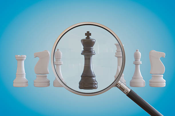 istock Magnifying Glass In Front Of Chess Pieces 2209792693