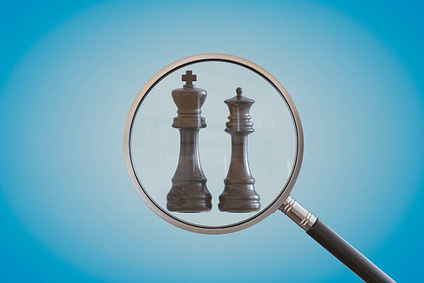 istock Magnifying Glass In Front Of Chess Pieces 2209792714