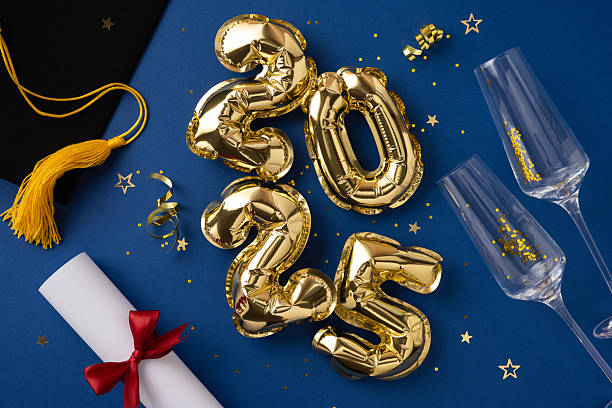 istock Graduation-themed composition featuring gold balloons, a diploma, and hat on a sparkling background 2209795553