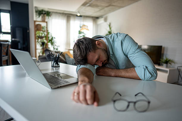 istock Exhausted freelancer sleeping on desk at home after work 2209795622
