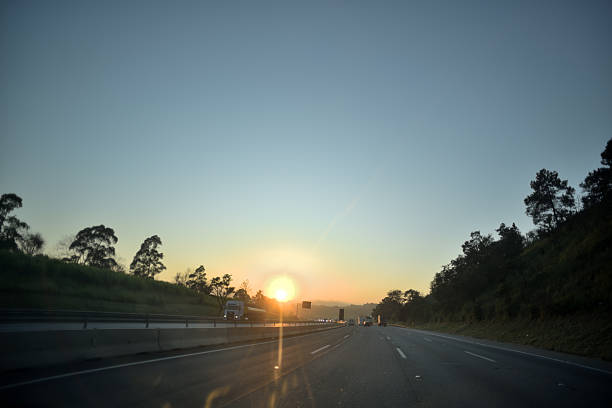 istock sun rising on the road 2209799359