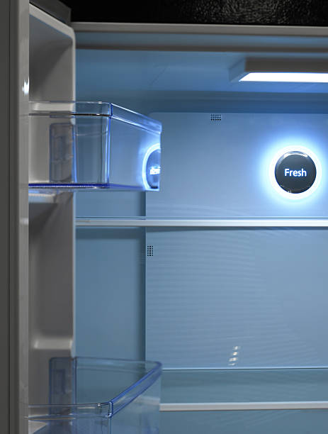 istock Inside of a modern, sleek, side-by-side refrigerator with a minimalist design. The appliance has a glossy, stainless steel finish that reflects light, giving it a polished appearance. 2209800018