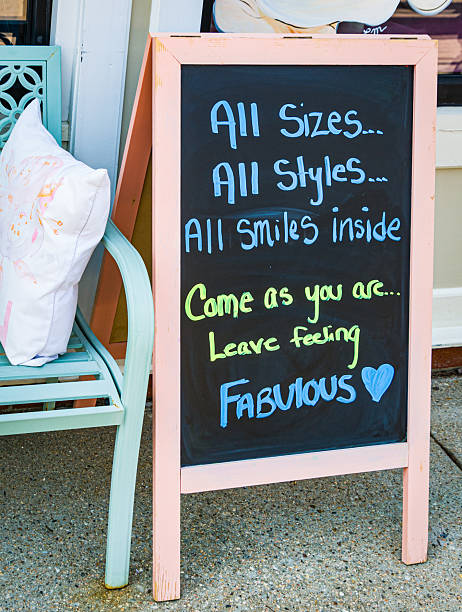 A pink  chalk board outside a clothing shop on Cape Cod sends a positive, inclusive message.