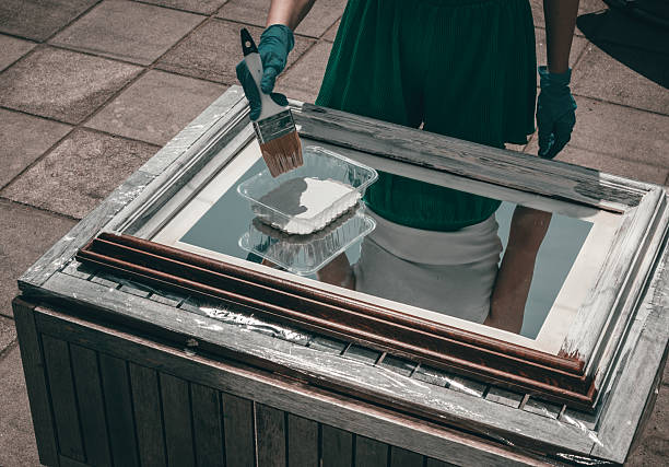 istock A young girl paints a mirror frame. 2209805273