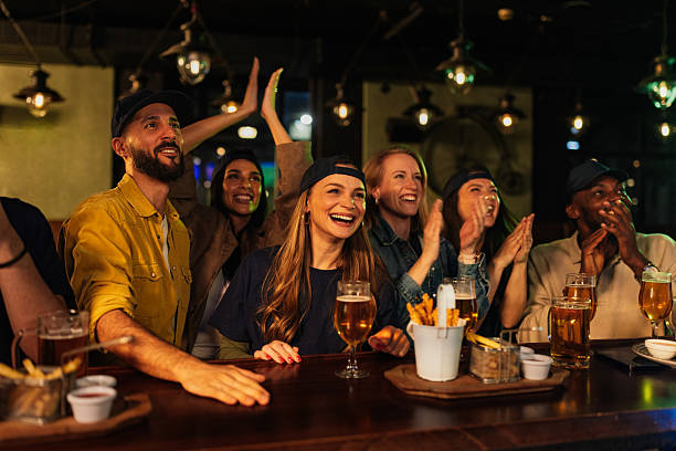 istock Enthusiastic friends cheering and drinking beer at the pub 2209806665