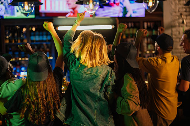 istock Friends celebrating and cheering while watching sports in a pub 2209806677