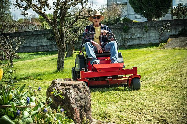 istock Man on riding lawn mower 2209807665